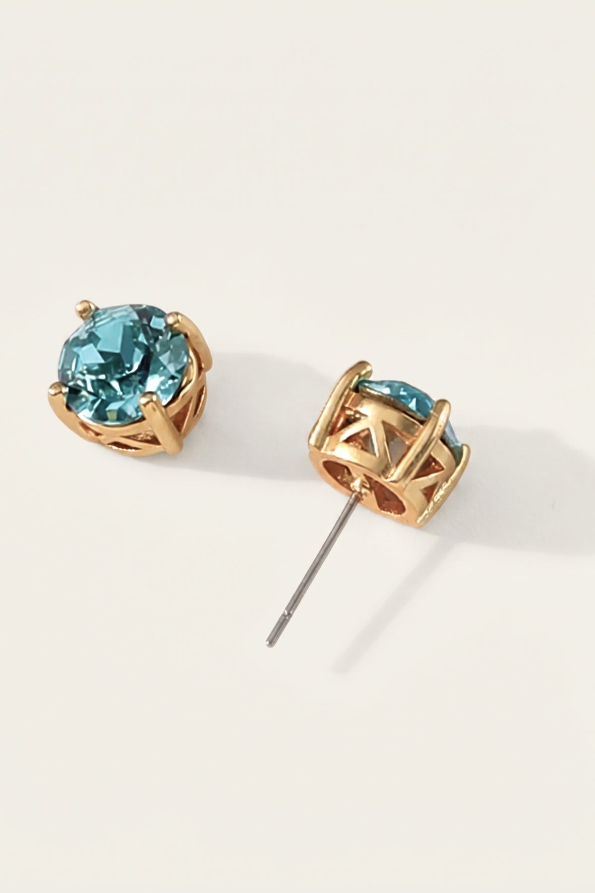 Turquoise Sparkle Stud Earrings on a cream background