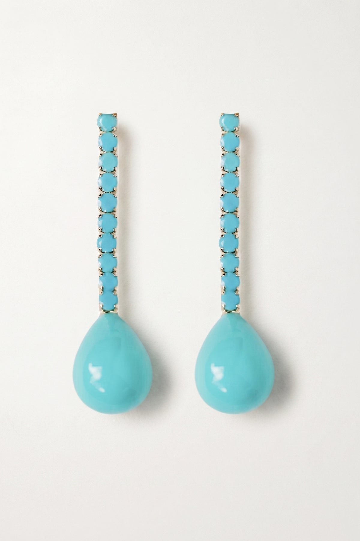 Turquoise Swingy Statement Earrings on a cream background