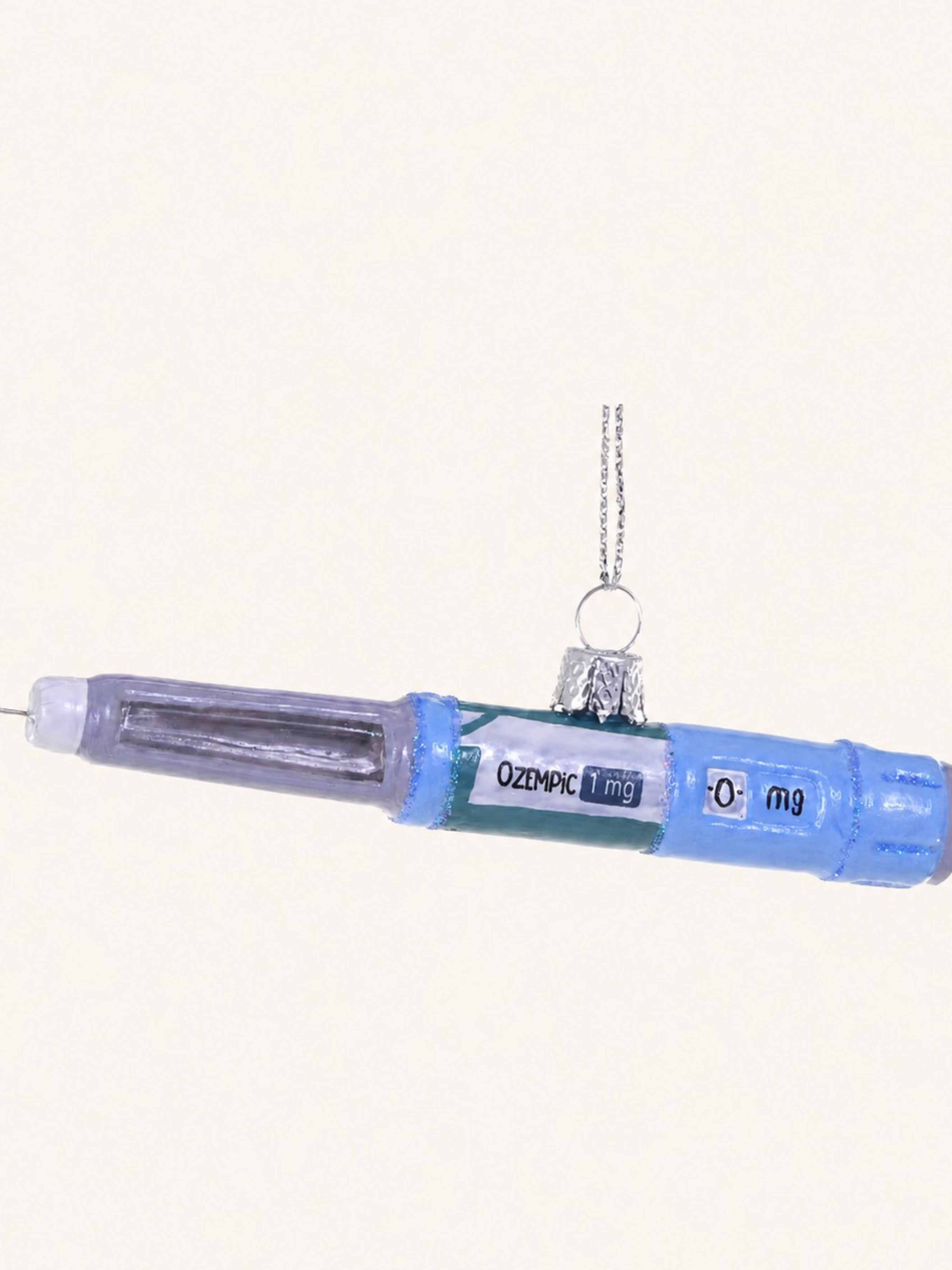 This is a close up of a weight loss injection ornament and is meant to have a sense of humor mocking today's world of injecton medications. 